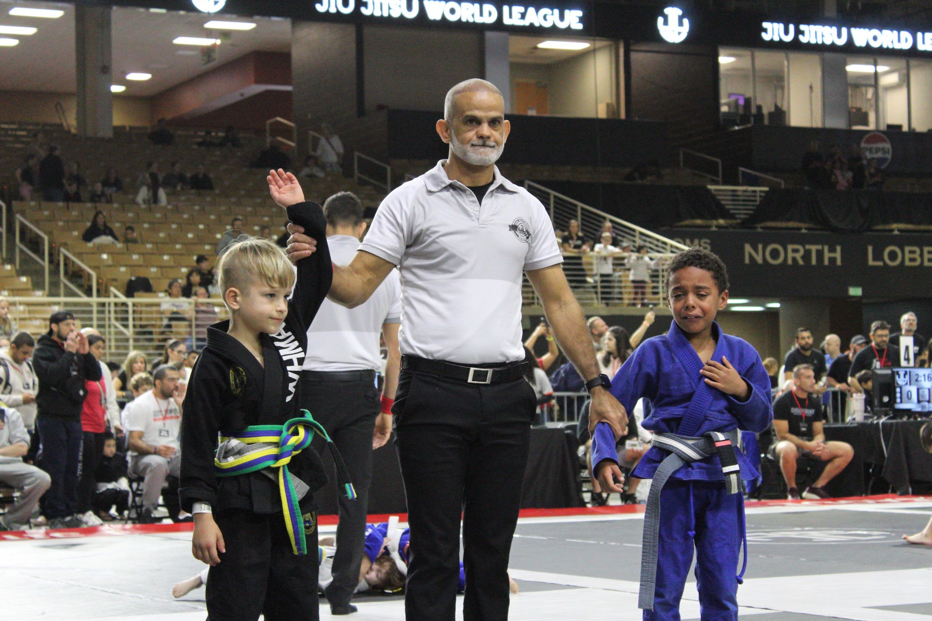 Young Winter Haven competitor getting his hand raised after winning at Jiu Jitsu World League