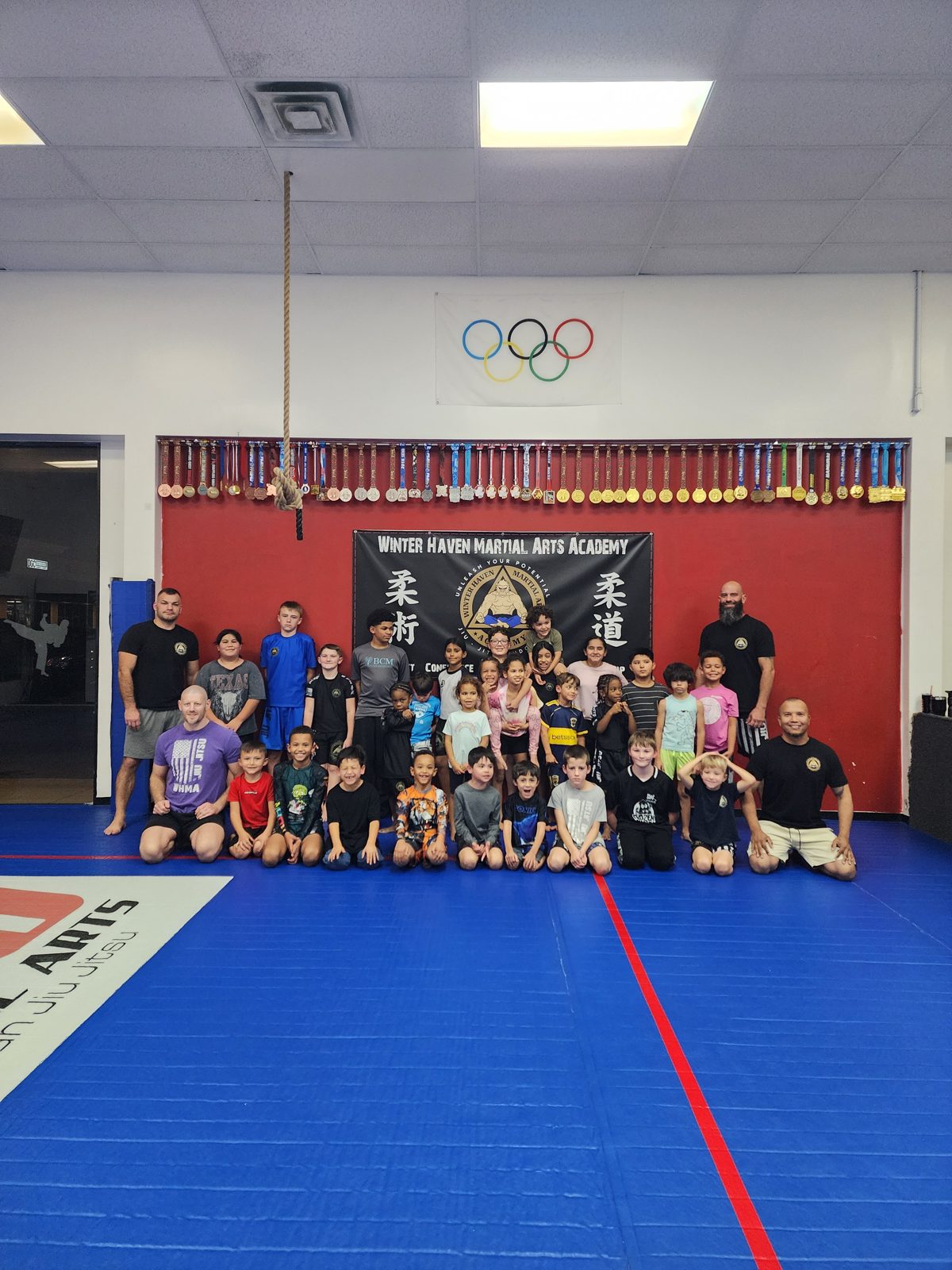 Kids jiu-jitsu class group photo on the mats in Winter Haven, FL